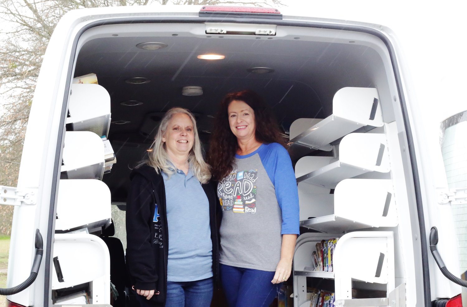 Librarian Mary Hurley (left) and Pam Hortman in the van after securing the books from a recent visit.